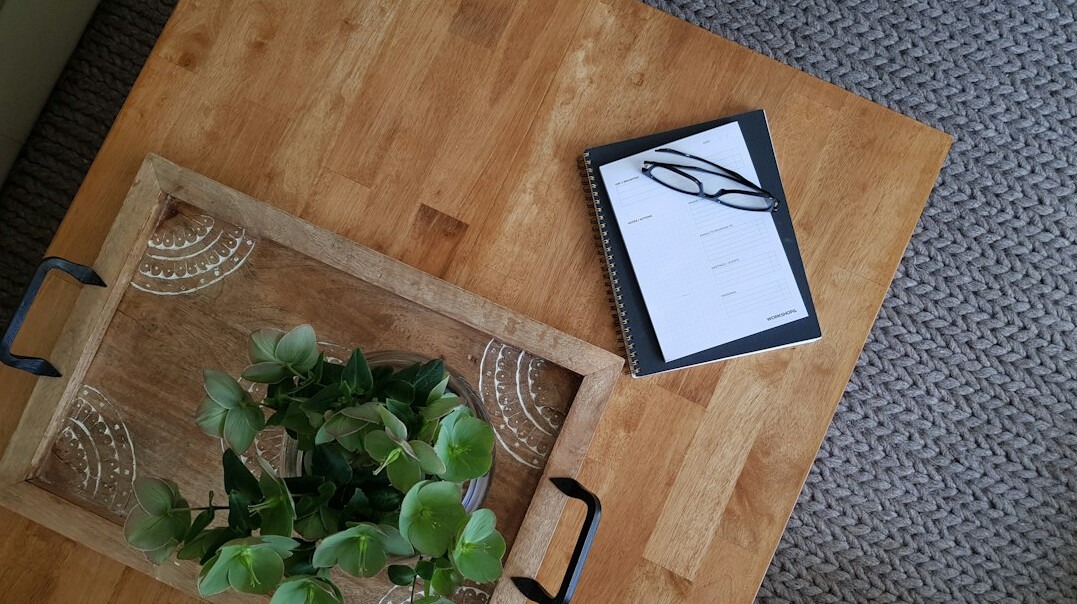 Handwritten research notes on a wooden desk
